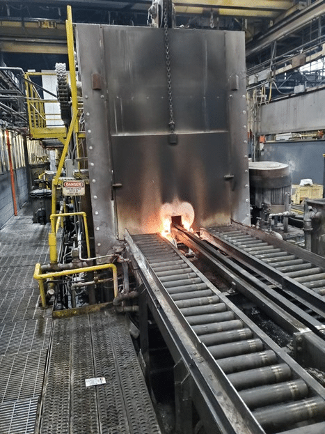 Carburizing furnace heating industrial gear parts to achieve optimal surface hardness and core toughness.